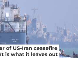 A small motorboat passes anchored vessels in the Strait of Hormuz off Bandar Abbas, Iran, on June 11, 2026. Amirhosein Khorgooi/ISNA via AP